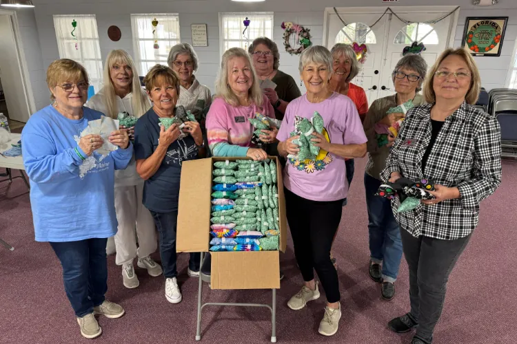 Volunteers sewing port pillows together